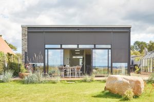 modern home with very large floor to ceiling windows covered by Luxaflex external screen