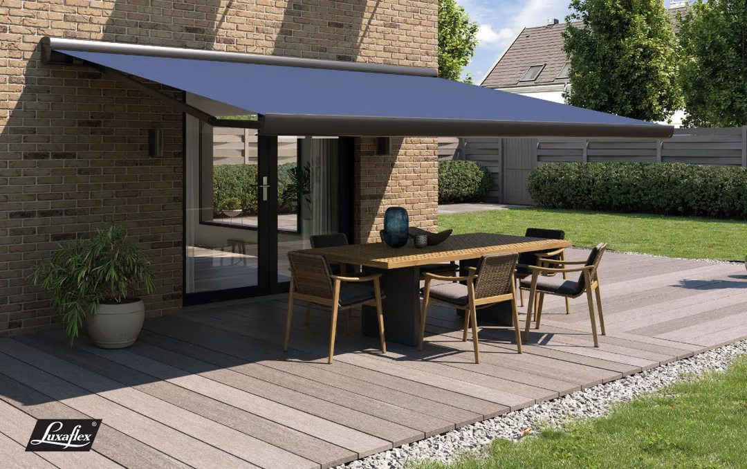 navy blue Luxaflex patio awnings in Sussex, partially covering a table and chairs