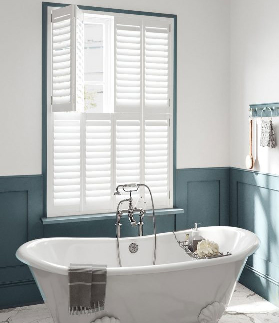 white and blue bathroom with tier-on-tier window shutters in West Sussex