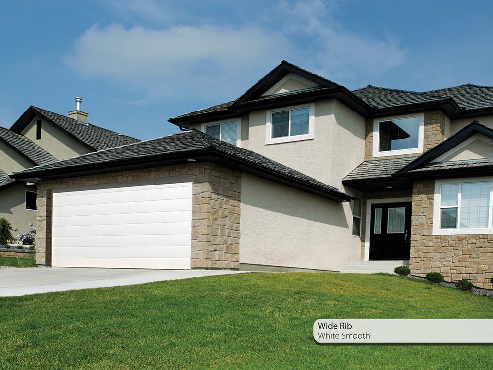 suburban house with driveway and seceuroglide sectional garage door installed on the front