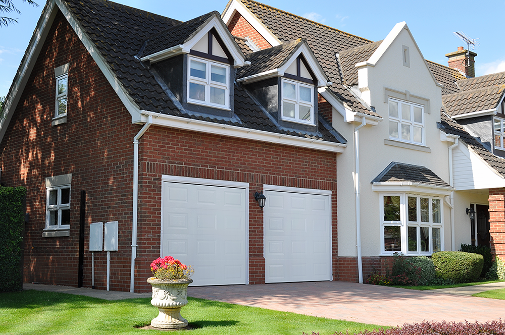 house in the UK with double seceuroglide sectional garage doors installed in white