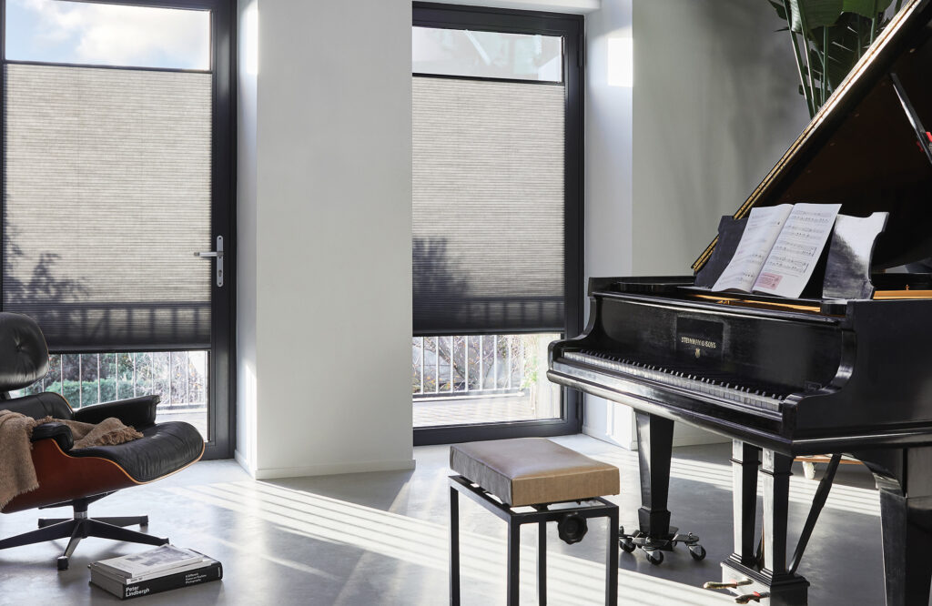 Luxaflex Duette blinds fitted to patio doors beside a grand piano