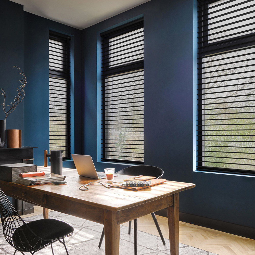 Black Venetian blinds fitted in a stylish home office
