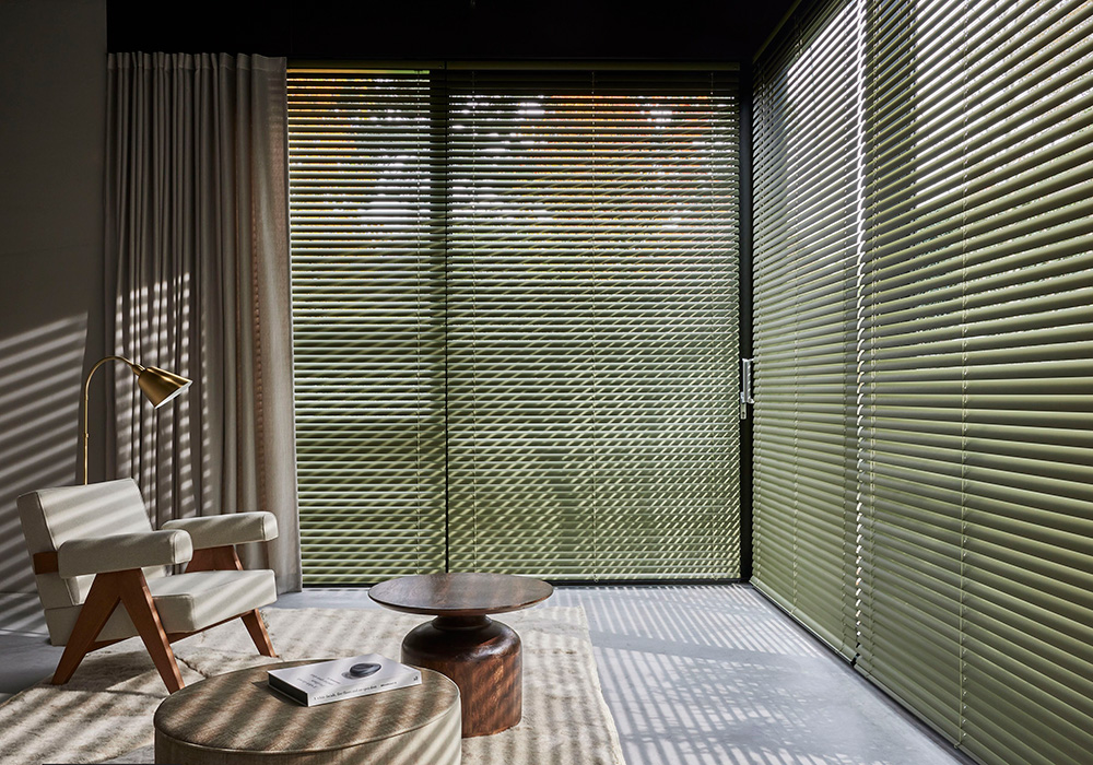 Venetian blinds fitted across large living room windows