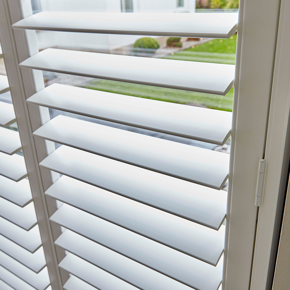 White plantation shutters in Horsham fitted to a modern window